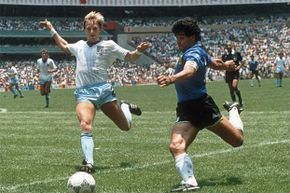 Argentinian forward Diego Maradona (R) readies to cross the ball under pressure from English defender Gary Stevens during the World Cup quarterfinal. This 1986 match is well-remembered for Maradona's 'hand of God' comment.