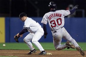 Yankees second baseman Chuck Knoblauch (L) drops the ball as he takes the throw in the top of the 10th inning from Derek Jeter; yet, the umpire ruled that Red Sox second baseman Jose Offerman was out.