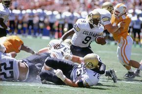 Wide receiver Mike Pritchard of the University of Colorado at Boulder carries the ball against the University of Tennessee in 1990; in another game that year, Colorado managed a rare fifth down which the referees didn't notice.