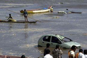 People gaze out at the floodwaters in Madras, India, after the December 2004 tsunami.