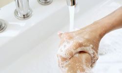 hands being washed at sink