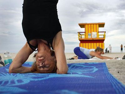 Yoga is well-known as a stress-busting workout, and many people in the workforce with financial worries during the U.S. economic downturn have taken advantage of its benefits. Here, a yoga class takes place by the ocean in Miami Beach, Fla., in 2008.
