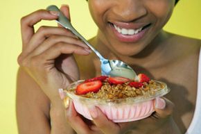 Person eating bowl of yogurt