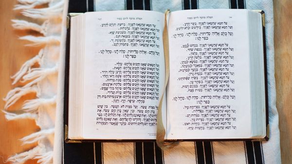 a siddur and tallit (prayer book and prayer shawl).