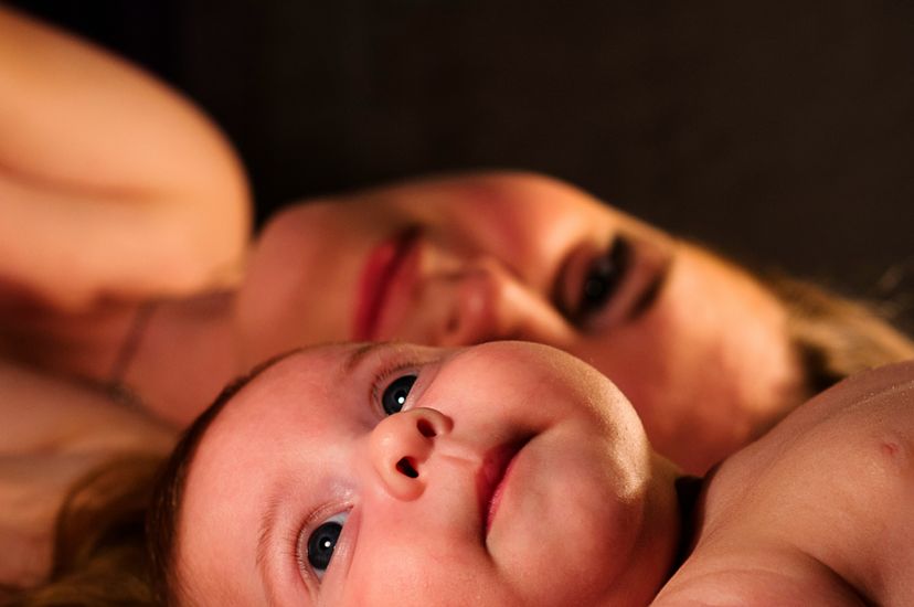 Older sister and baby laying down