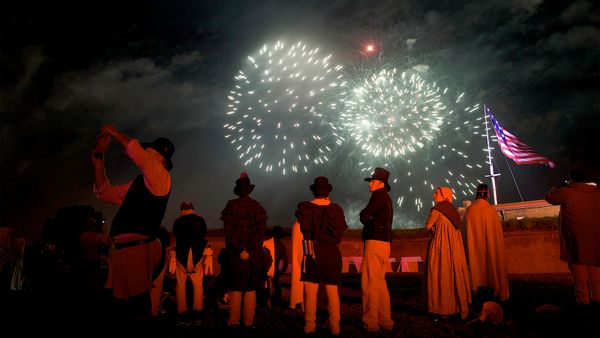 Men celebrating traditional festival at night.