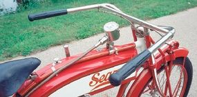 The Deluxe's tank-mounted speedometer was driven off a spiral gear on the rear hub.