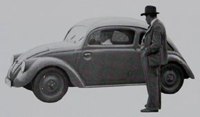 The Volkswagen Beetle was born from a desire to put the Third Reich on wheels. Here, Ferdinand Porsche observes a 1930s Beetle prototype. See more Volkswagen Beetle pictures.