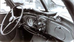 Horned ducts atop the symmetrical dashboard fedthe 1935 Peugeot 402's optional heater/defroster.