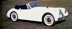 A 1954 example of the costlier, more powerful XK-120MC in drophead (convertible) form, here with disc wheels.