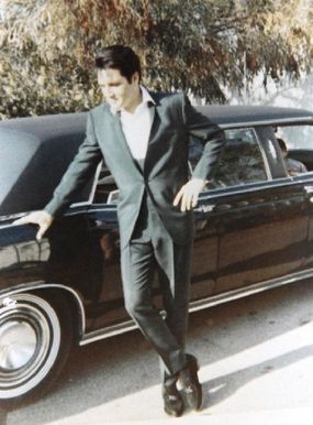 Elvis Presley admires the 1967 Lincoln Executive Limousine given to him by longtime manager Colonel Tom Parker.