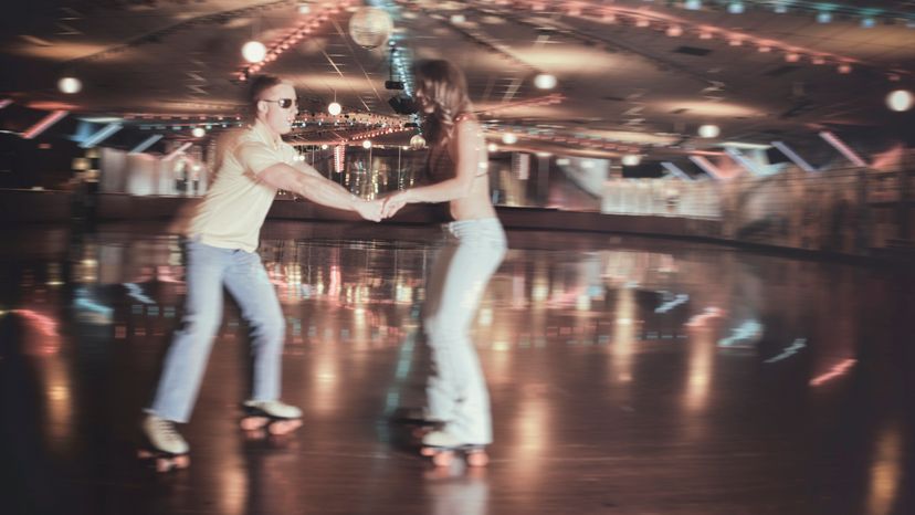 A blurred motion image of a 70s couple at a roller disco. 