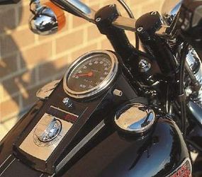 The tank-mounted instrument panel and handlebarrisers, usually finished in chrome, wereblack on the Bad Boy.