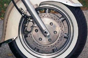 Large brake discs hide seven-spoke cast wheels.