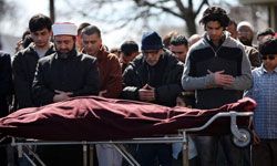 Mourners praying at Muslim funeral