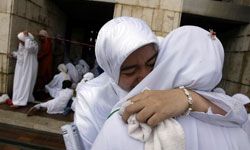 Muslim women hugging at funeral