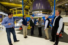 NASA visits with Blue Origin founder Jeff Bezos, third from left, in December 2011. You can see Blue Origin's crew capsule in the background.