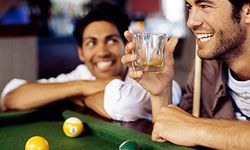 Guys playing pool and drinking