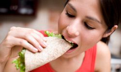 woman eating wrap