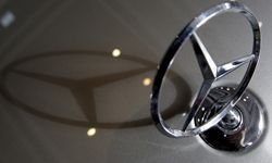 A Mercedes-Benz logo casts a shadow