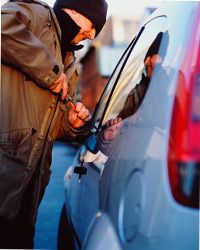 Thief breaking into car