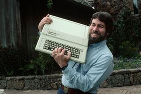 Steve Wozniak, designer of the Apple I and II series, shows off an Apple IIe. And a great belt buckle.