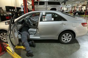 Toyota service technician Tungyio Saelee performs a recall repair on an accelerator pedal from a brand new Toyota Corolla at City Toyota on Feb. 5, 2010, in Daly City, California.