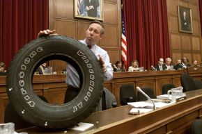 Congressman Fred Upton (R-MI) displays a Firestone tire with tread separation that came off a friend's Ford Explorer on June 19, 2001, during an oversight and investigations hearing of the Commerce, Trade, and Consumer Protection subcommittee.