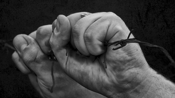 Monochrome close-up of men's hands.