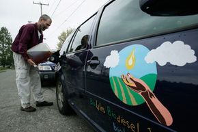 Lyle Rudensey fills up his car with homemade biodiesel that he refined from used cooking oil in his garage, on April 22, 2009, in Seattle, Wash.
