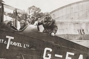 Paul Poiret posing before airplane