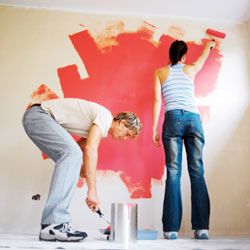 Couple painting wall red