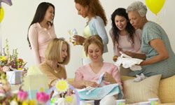 Women opening gifts at baby shower