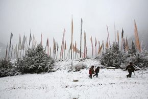 A group of boys play in the snow in rural Tibet.