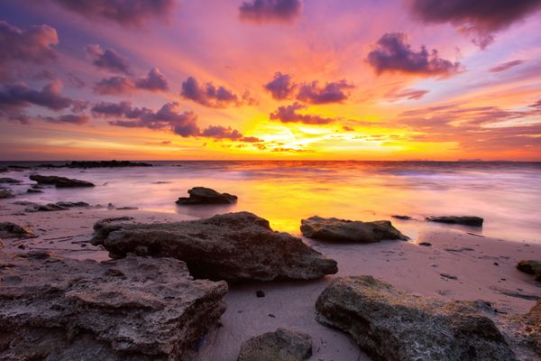 Sun setting over tranquil water at dusk.