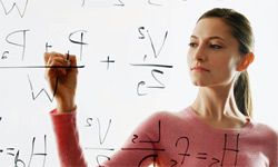 Woman writing math equations