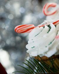 A mini candy cane adds a touch of holiday flair to a cupcake.