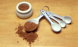 Cocoa makes a delicious dusting powder to use in concert with cupcake stencils.