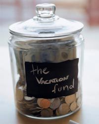 coins in a jar labeled "vacation fund"