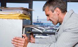 man slamming shut a file cabinet drawer