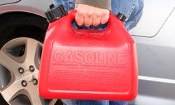 Man holding red gas can