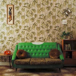 A bright green couch in a vintage-inspired living room.