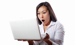 Shocked woman with laptop