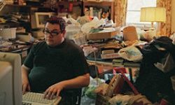 man in cluttered room