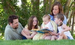 family reading outside