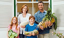 family holding vegetables