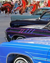 Mexican dancers and musicians perform near a display of customized lowrider automobiles in Anaheim, Calif.