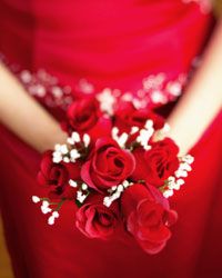 Bridesmaids in rich red gowns with velvety red roses make a big visual impact.