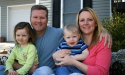 man with family and house