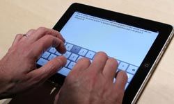 hands typing on a iPad